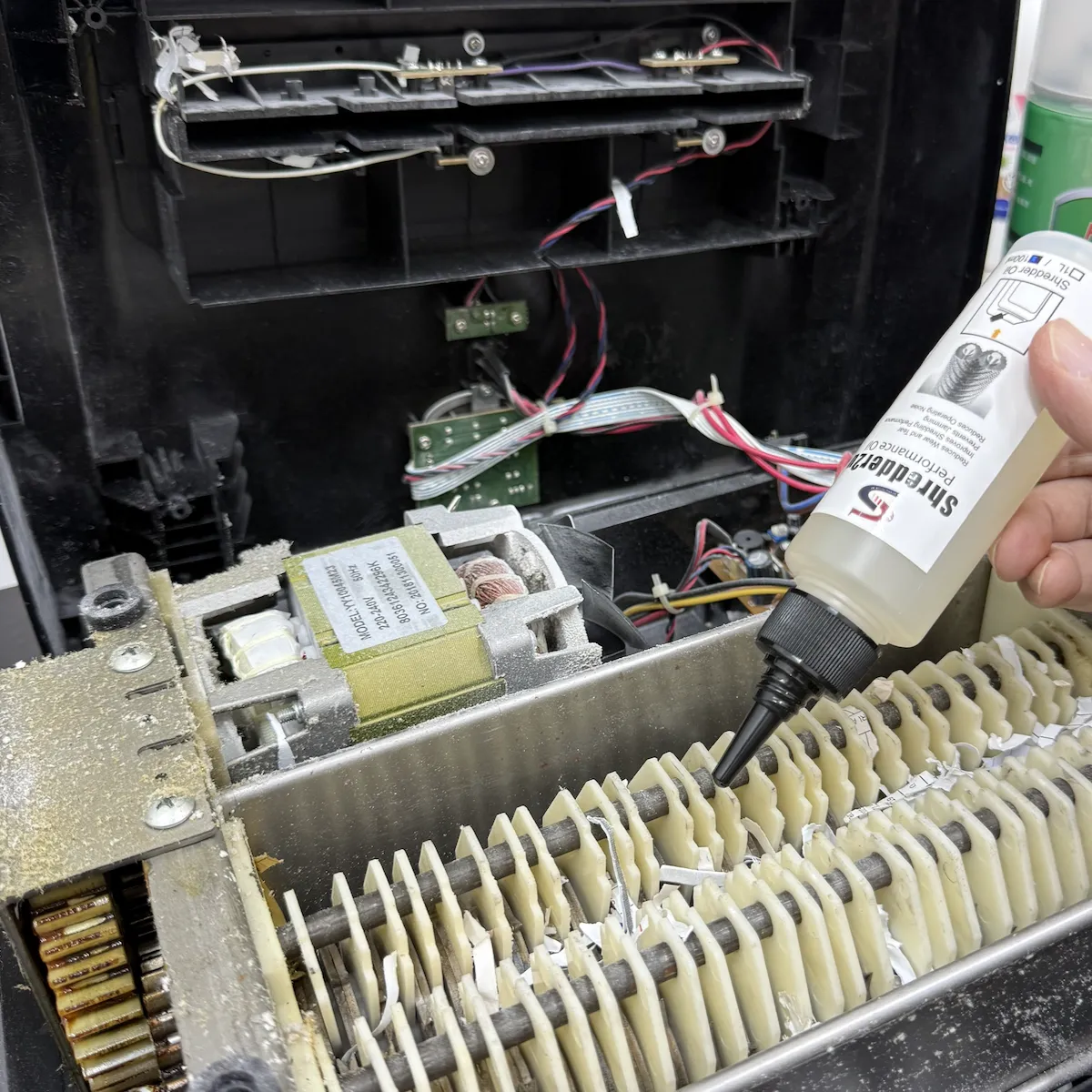 Dust-clogged shredder motor and cutting blades before service